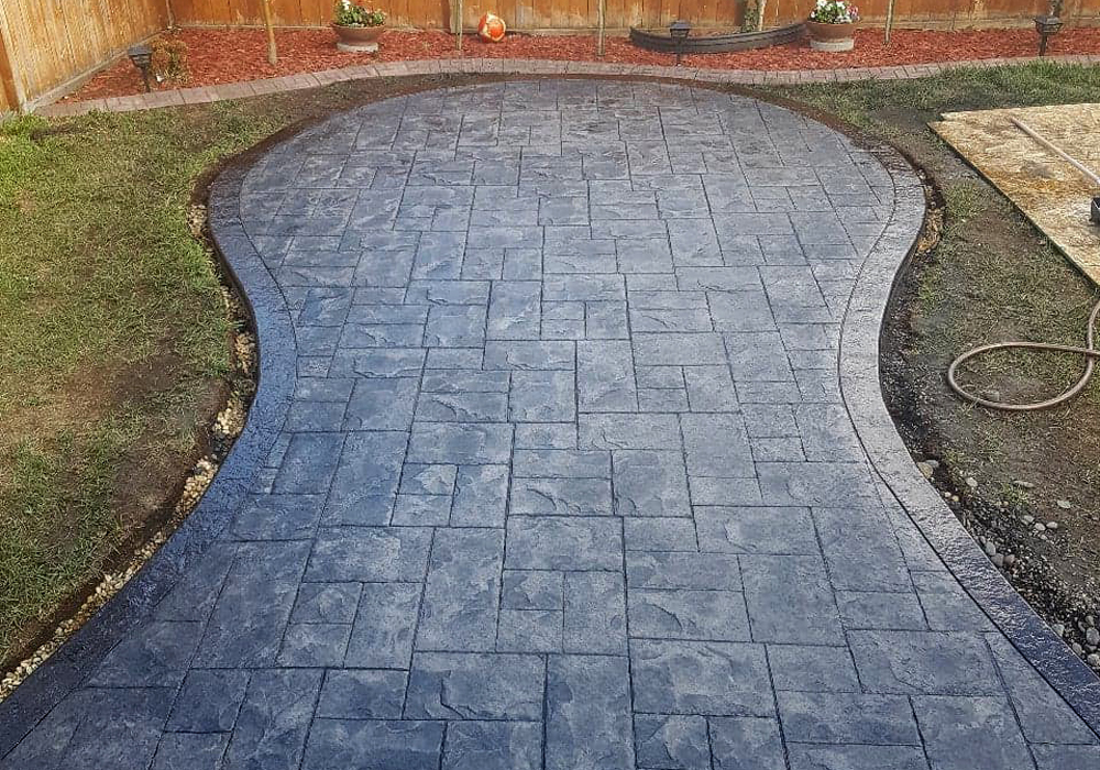 Decorative stamped concrete Patio with Acid stained border